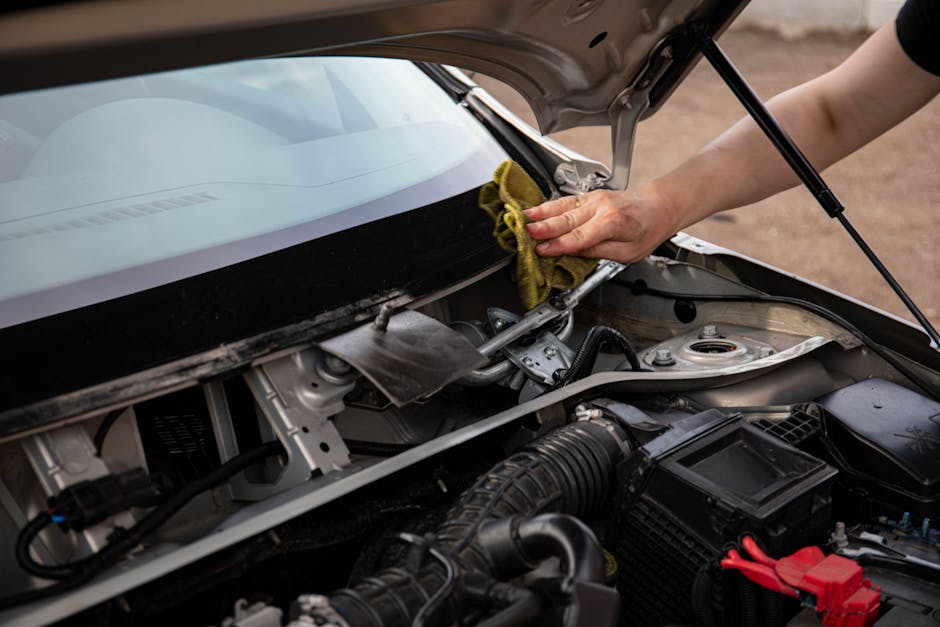Mechanic performing auto glass chip repair